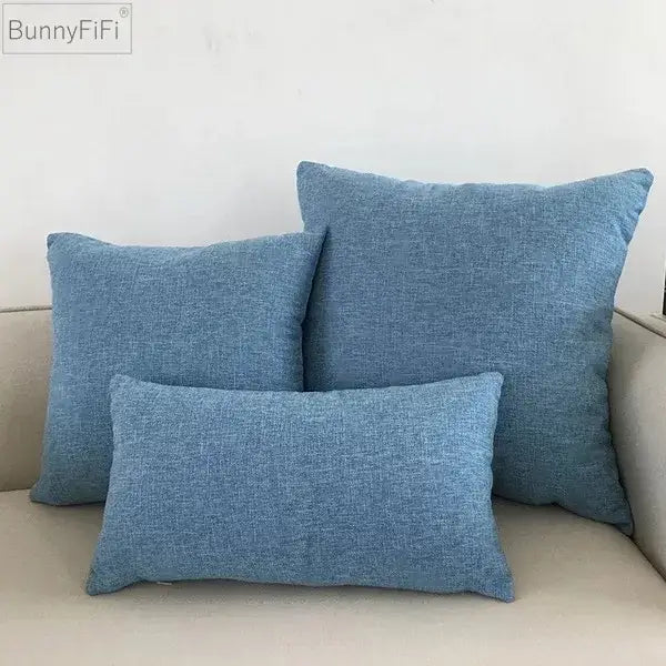 Set of three blue textured fabric throw pillows in varying sizes on a beige decorbites ivory sofa cushion cover
