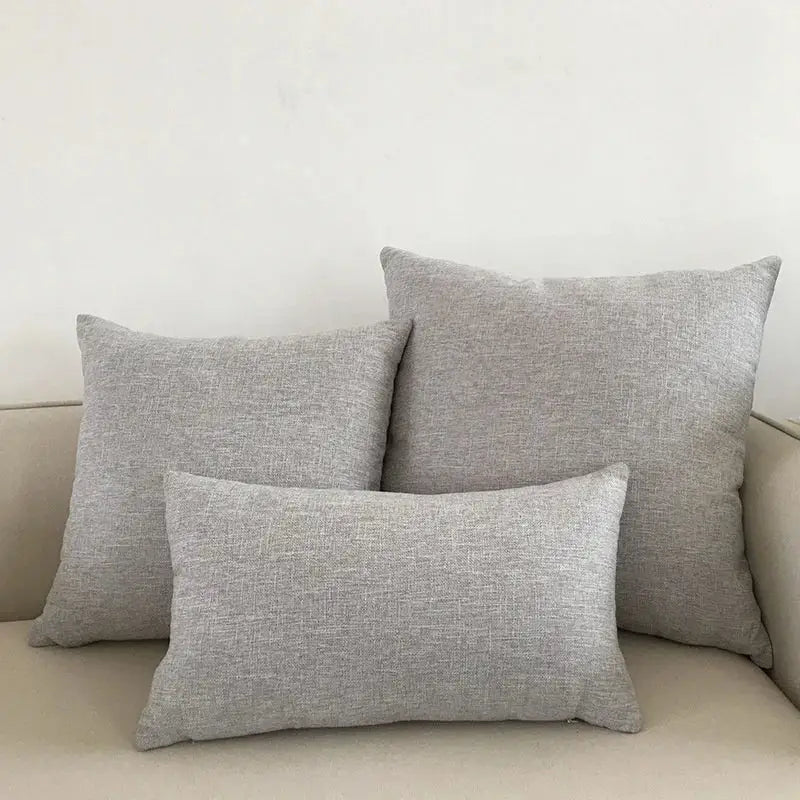Set of three gray textured throw pillows with woven cushion cover on beige decorbites ivory sofa for living room decor