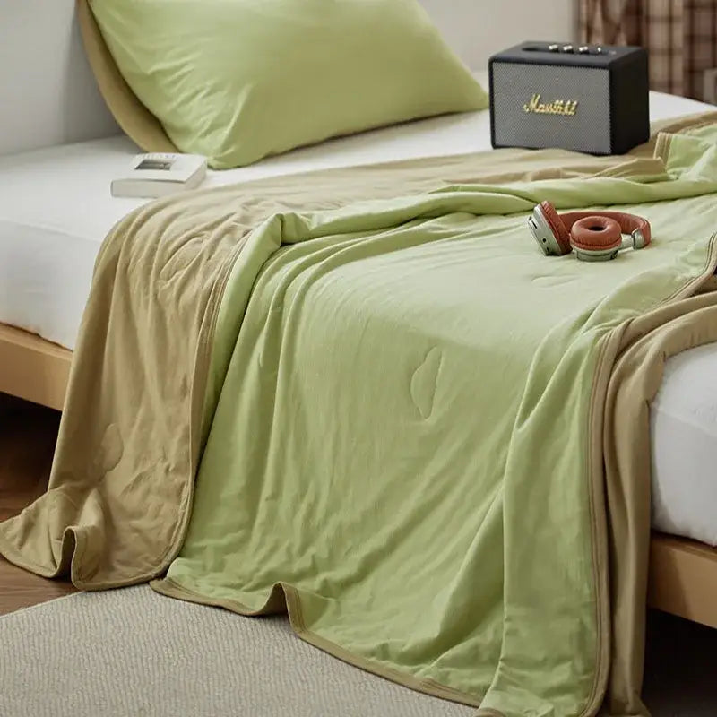 A soft two-toned green and beige decorbites cotton summer comforter with plush texture for bedroom cooling