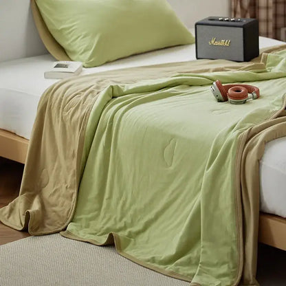 A soft two-toned green and beige decorbites cotton summer comforter with plush texture for bedroom cooling