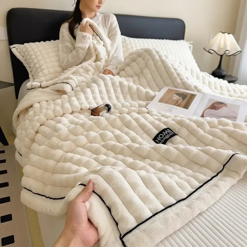 Cream-colored plush quilted throw blanket with black piping trim and soft texture for decorbites cozy flannel velvet