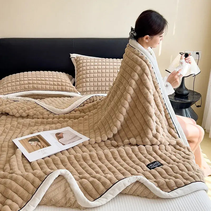 Beige plush quilted decorbites cozy flannel velvet blanket with white fleece trim and hom brand label for bedroom decor