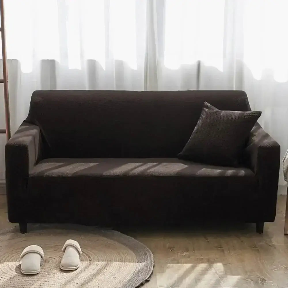 Dark brown stretchy sofa slipcover with matching textured pillow made of decorbites cozy fleece for living room furniture wrap