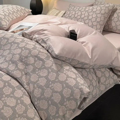 A soft blush-pink satin duvet cover with subtle gray rose pattern in a textured soft yellow decorbites cotton bedding set