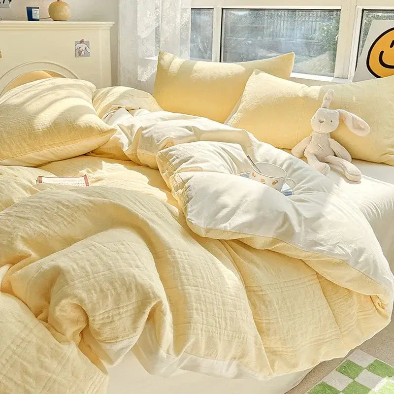 Soft pale yellow textured decorbites cotton three-layer bedding set with quilted duvet pillows and plush bunny toy