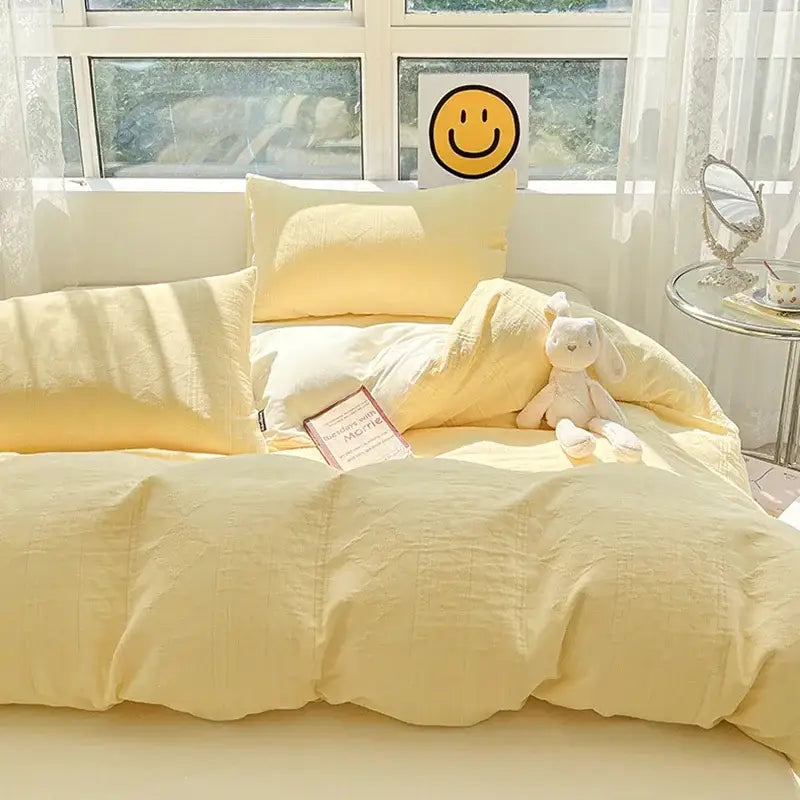 Soft yellow textured decorbites cotton three-layer bedding set with duvet pillows and plush bunny toy on bed