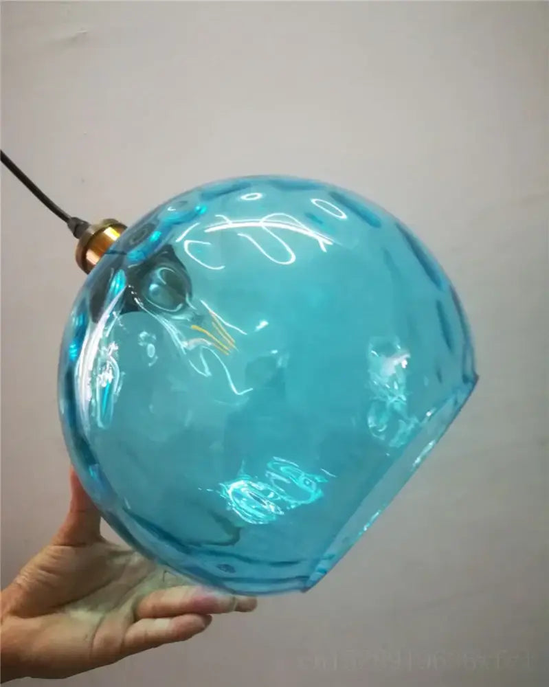 Textured turquoise blue glass ball pendant light with faceted surface and brass fixture for kitchens decorbites blue glass pendant lights