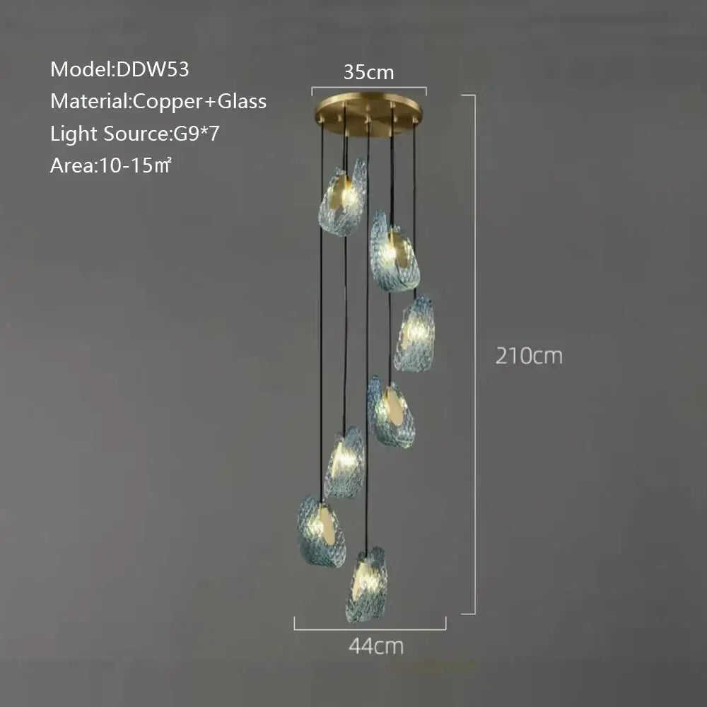 A modern blue glass luxury wall sconce with textured turquoise shades and brass mount for stylish bedroom decorbites decor