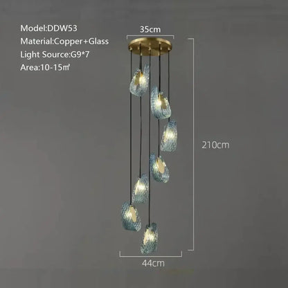 A modern blue glass luxury wall sconce with textured turquoise shades and brass mount for stylish bedroom decorbites decor