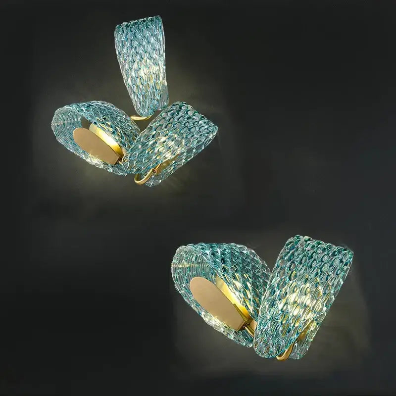 A pair of textured turquoise blue glass luxury wall sconces with gold metal accents for bedroom decorbites blue glass decor