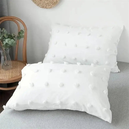 White pillow with soft textured fabric and pom-pom embellishments in decorbites furball double duvet set bedding