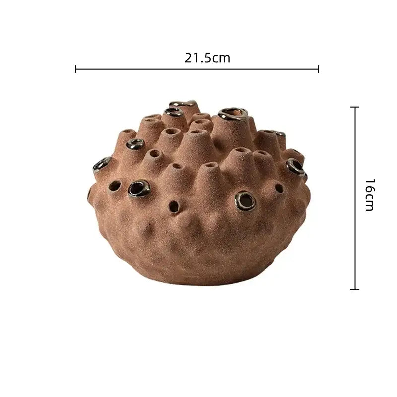 Brown ceramic coral ball vase with textured bumpy surface and multiple openings for decorbites coral ball decor