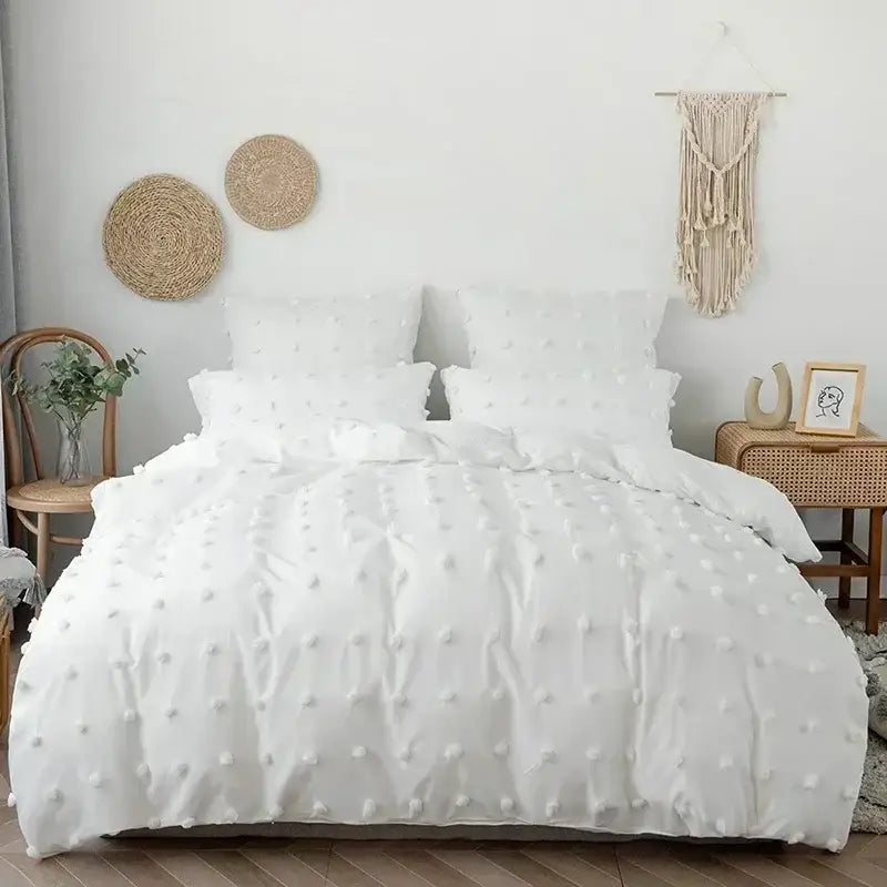 Textured white quilt cover set with soft fluffy pom pom embellishments ideal for bedroom bedding