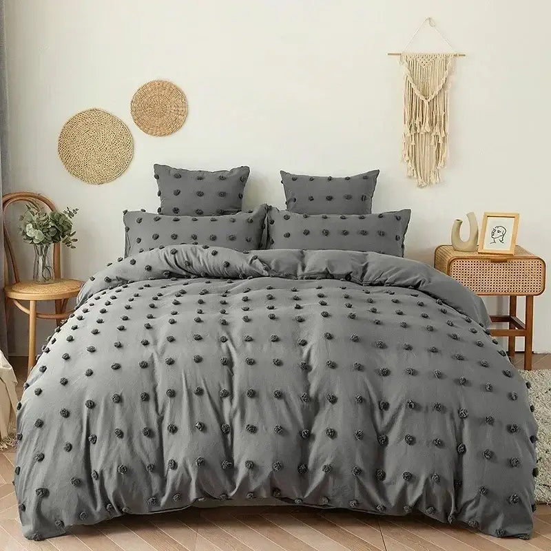 Gray duvet quilt cover set with black pom-pom embellishments for textured white pom pom bedroom bedding