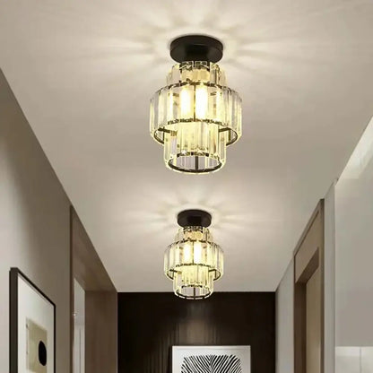 Two tiered decorbites black gold minimalist led chandeliers with black metal bases and warm glowing lights for kitchen lighting