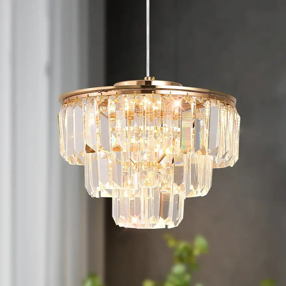 Tiered gold crystal led pendant light with a metal frame and cascading clear faceted crystals for dining room decorbites crystal led