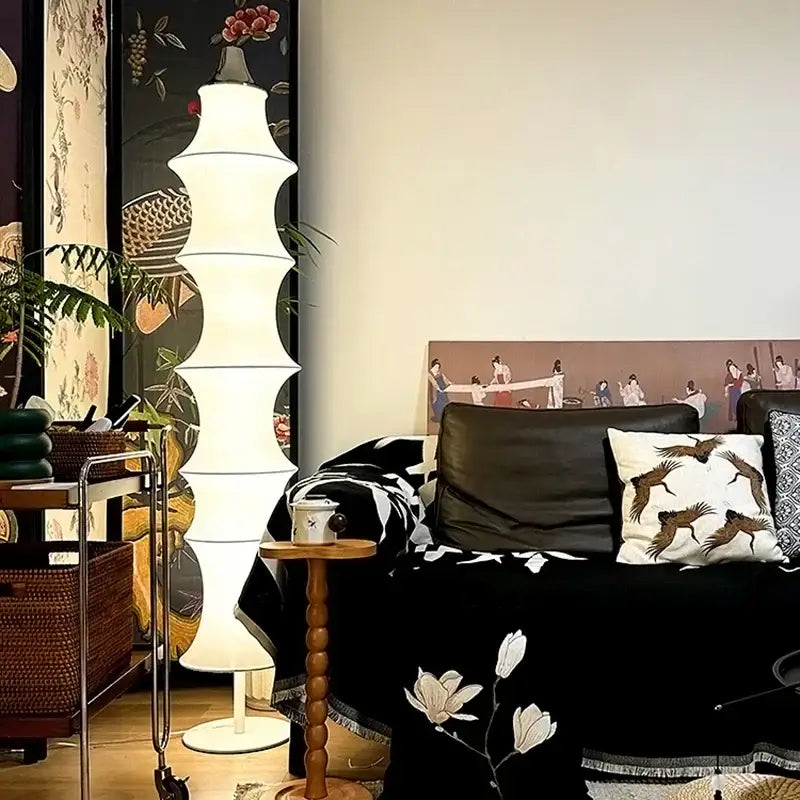 A tall white segmented floor lamp with a modern tiered design in cream silk japanese for living room decorbites cream silk