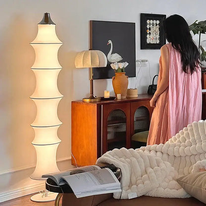 Tall tiered floor lamp with cream silk japanese shade and black metal accents for soft living room lighting decorbites cream silk