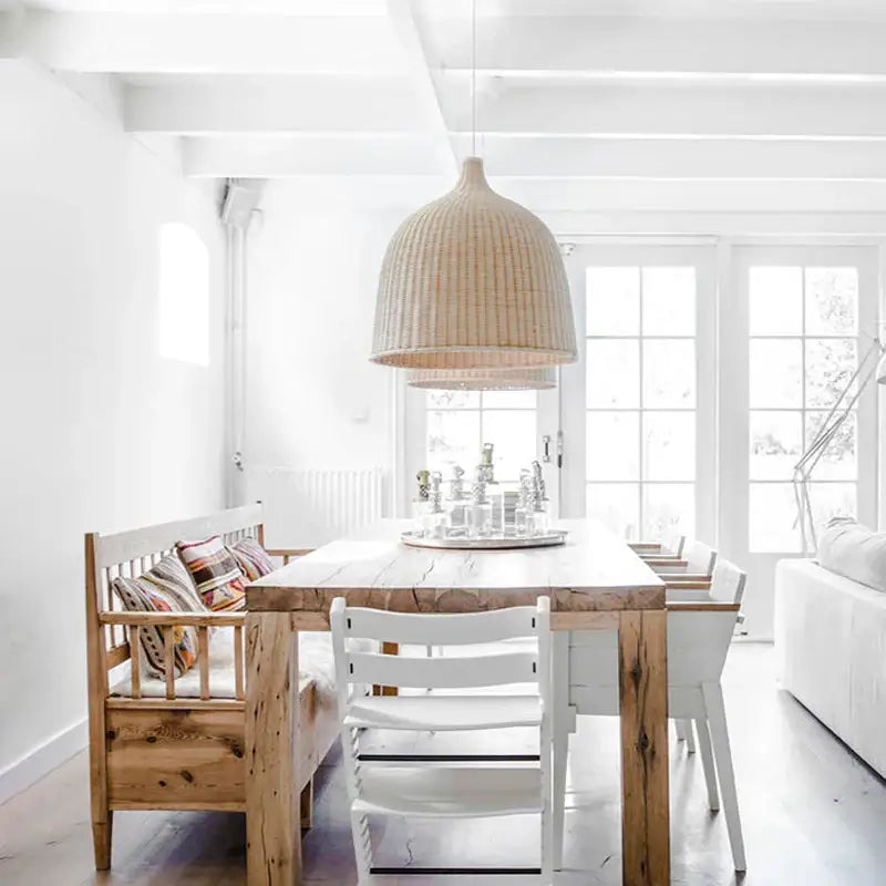 A natural beige tiered bamboo weaving led pendant light hangs above the dining table for ambient lighting
