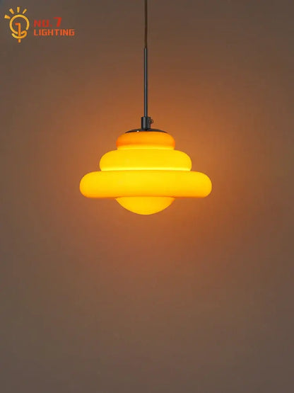 Warm yellow tiered decorbites cream glass pendant light with sleek black metal rod for kitchen lighting