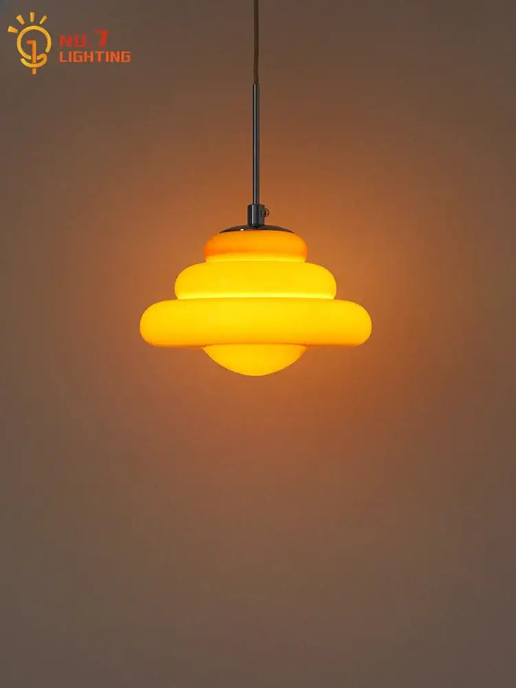 Warm yellow tiered decorbites cream glass pendant light with sleek black metal rod for kitchen lighting
