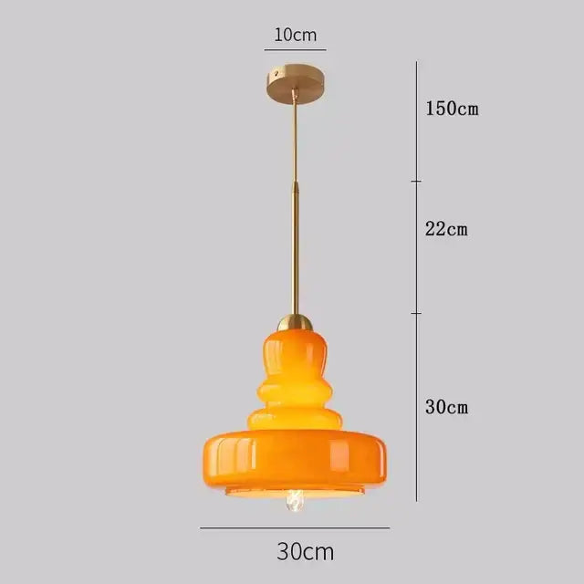 A warm amber glass pendant light with brass accents and metal chain ceiling mount for kitchen pendant lights ceiling