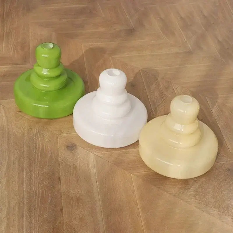 Three glossy tiered glass pendant lights in green white and beige with brass accents for kitchens ceiling lighting