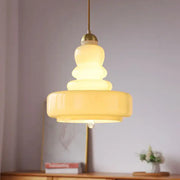 Tiered yellow glass pendant lights with brass accents featuring translucent glass bodies for kitchens ceiling pendant lights