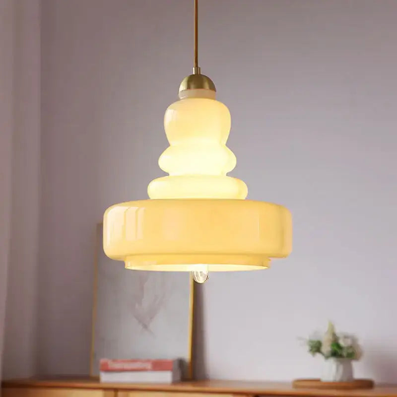 Tiered yellow glass pendant lights with brass accents featuring translucent glass bodies for kitchens ceiling pendant lights
