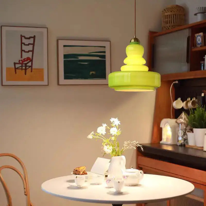 Vibrant lime green tiered glass pendant lights with brass accents for kitchens hanging from a pendant lights ceiling fixture