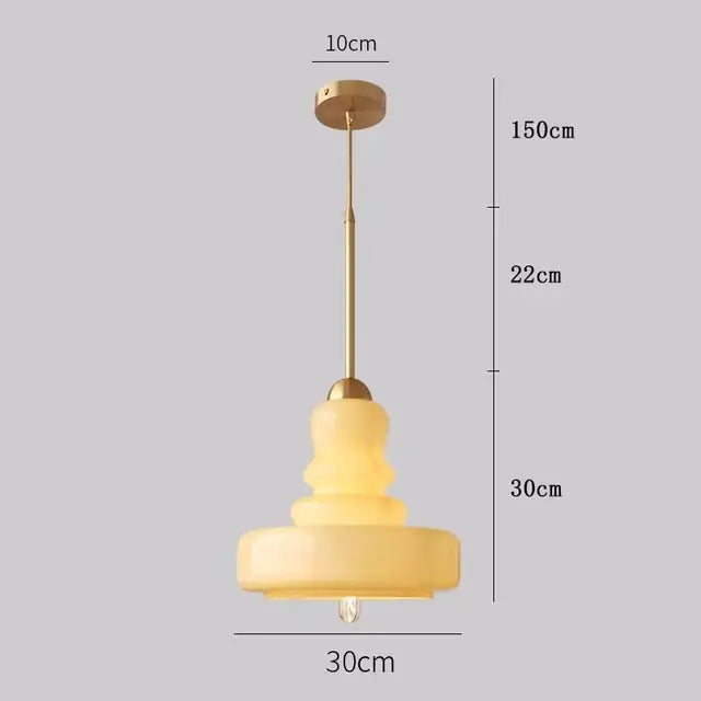 Warm tiered pendant lights with brass accents and yellow glass pendant lights ceiling for kitchens