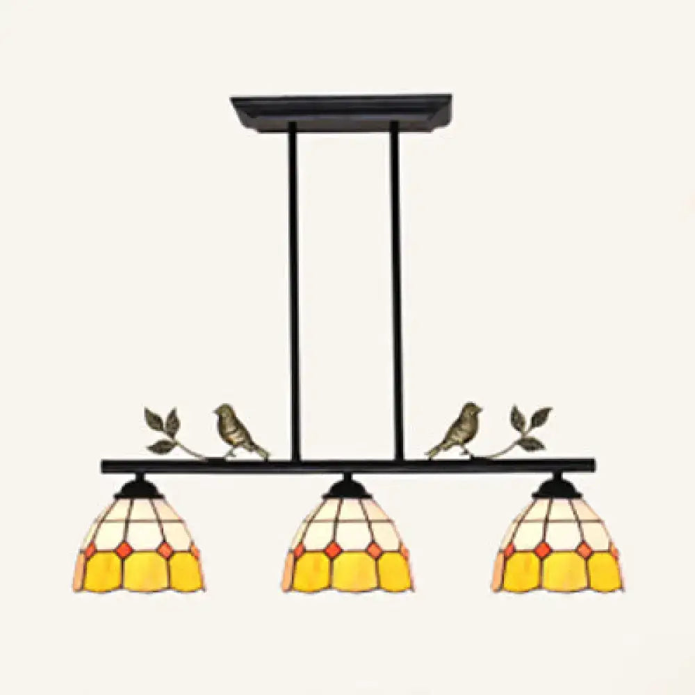 Black metal pendant light with three yellow cream stained glass shades and bird accents in black antique brass finish