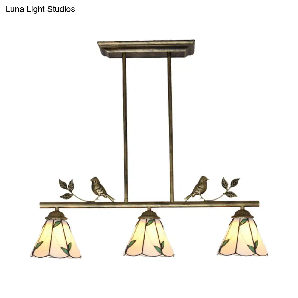DecorBites™ antique brass island lighting fixture with three green leaf stained glass shades and bird figurines
