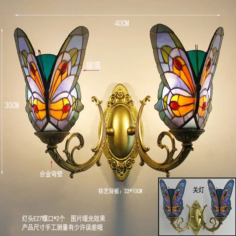 Ornate gold-toned butterfly glass sconces with vibrant orange and purple shades for bedroom wall lamps by decorbites