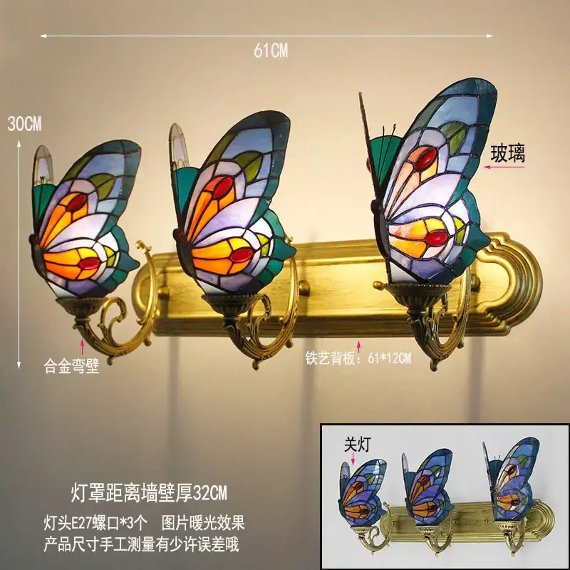 Set of three decorbites butterfly glass sconces with colorful stained glass wings and brass bases as wall lamps for bedroom decor