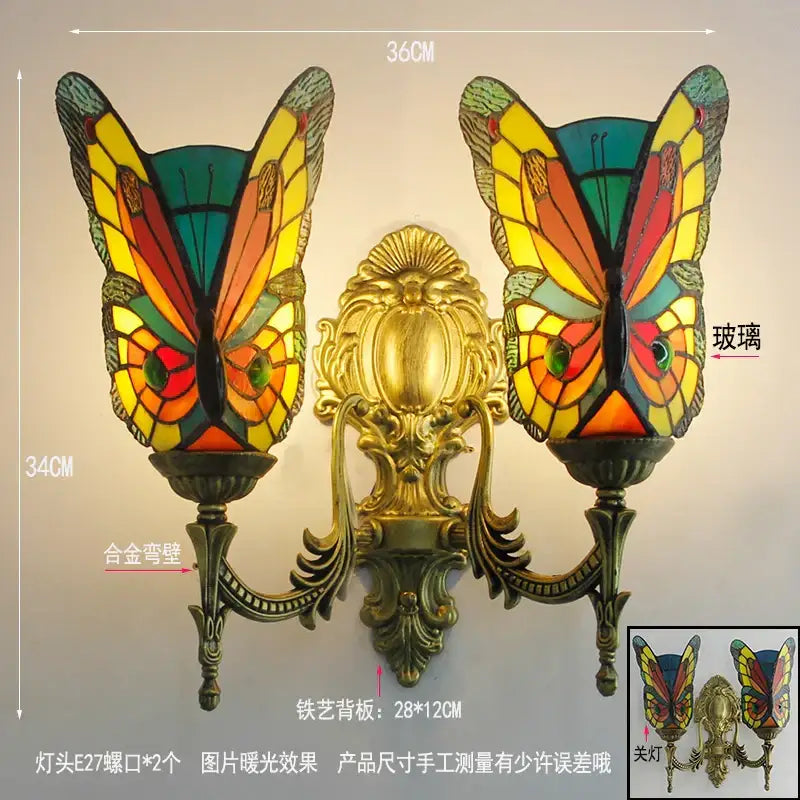 Vibrant butterfly glass sconces with stained glass butterfly and ornate gold-toned brass arms wall lamps decorbites
