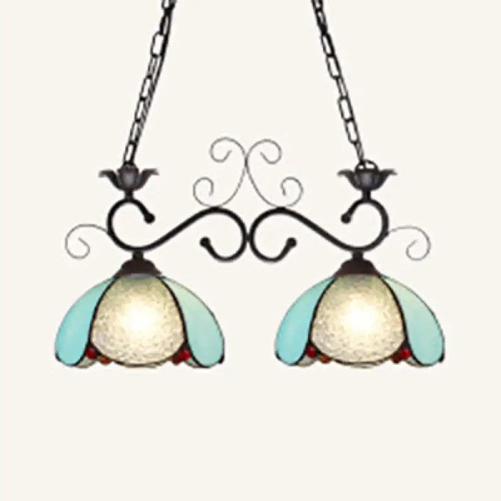 A pair of DecorBites™ stylish tiffany pendant lamps with black wrought iron and blue stained glass shades for dining room