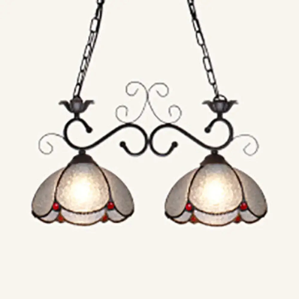 Vintage-style scalloped edged island light with black wrought iron arms frosted glass shades and red bead accents