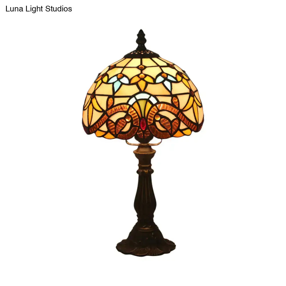 A vintage tiffany stained glass table lamp with floral amber and blue shade on a dark bronze base 110v-120v