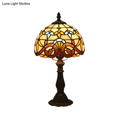 A vintage tiffany stained glass table lamp with floral amber and blue shade on a dark bronze base 110v-120v
