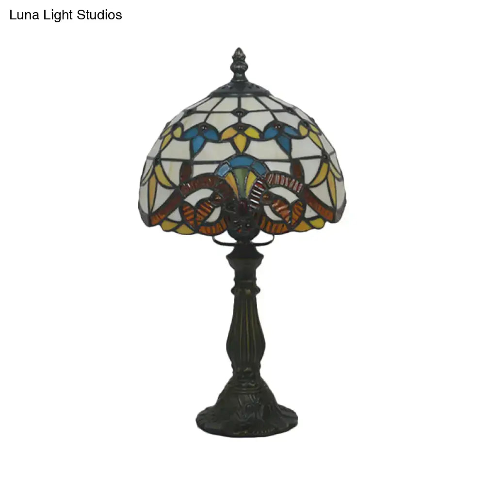 A tiffany stained glass table lamp with blue and pink floral shade on an ornate bronze base 110v-120v floor lamp
