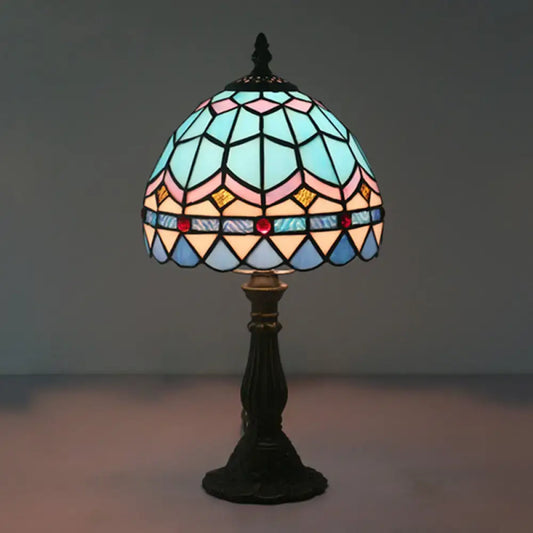 A tiffany stained glass table lamp with a dome shade in blue pink gold and red beads 110v-120v for bedroom use