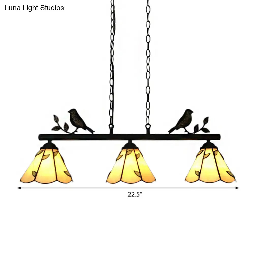 Black metal DecorBites™ pendant light with three amber cone stainless glass shades and bird accent for island lighting