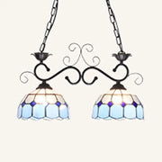 DecorBites stunning Tiffany-style pendant light with blue and white stained glass and ornate black metal arms