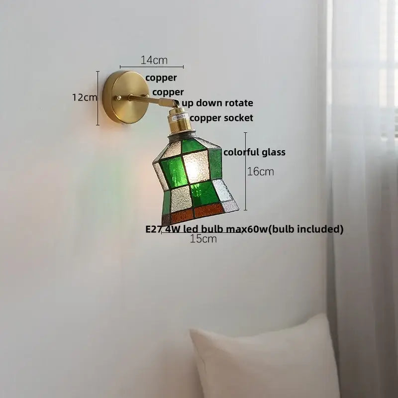 A vintage-style wall sconce with copper finish and decorbites colorful square glass shade for bedroom wall lights