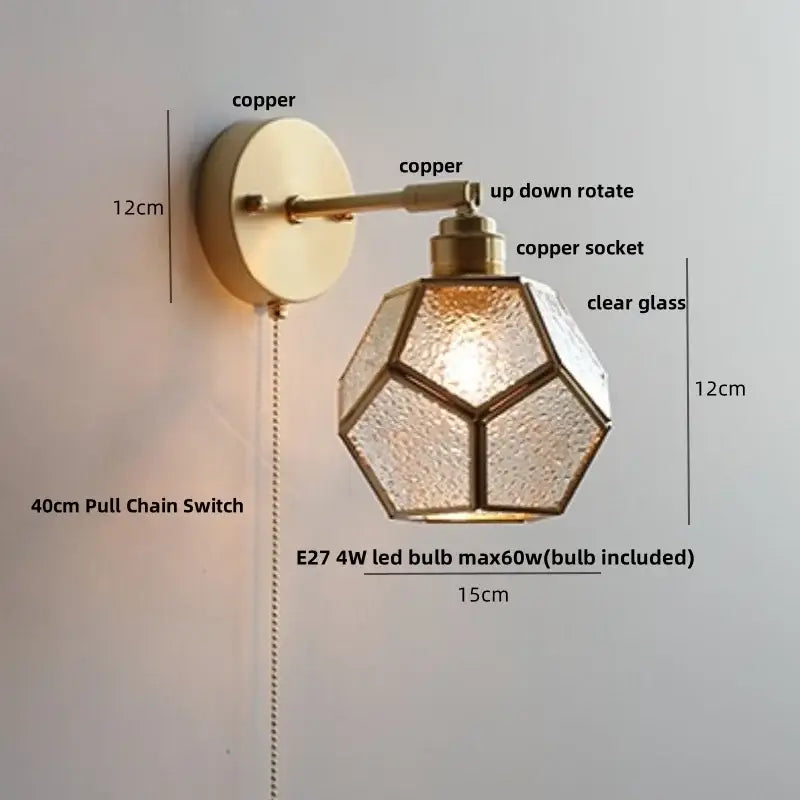 A brass-finished copper wall sconce with faceted clear glass shade and up-down rotating arm for decorbites colorful square wall lights
