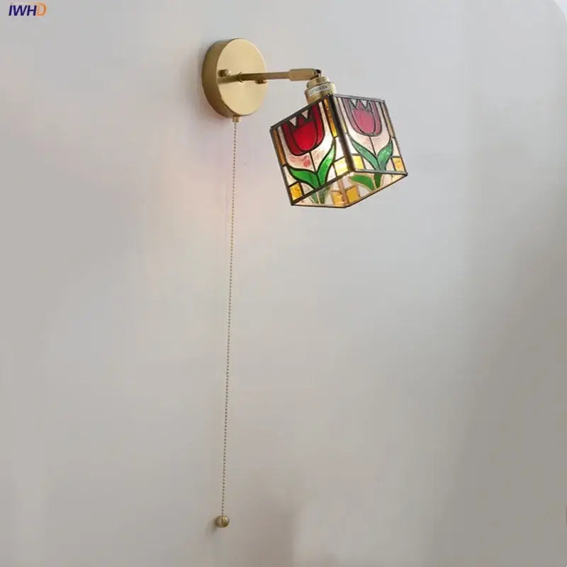 A brass-finished wall sconce with colorful square glass shade featuring red tulips for decorbites wall lights