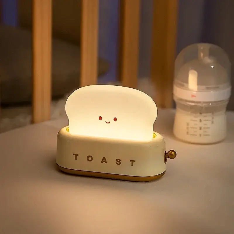 Cream-colored toaster shaped maker night light with glowing bread slice and red dot eyes usb lamp for bedroom use