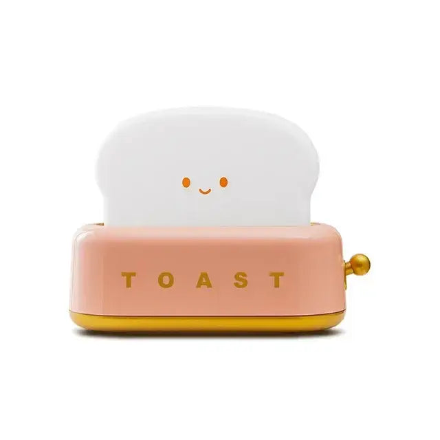 A cute pink and gold toaster shaped usb lamp night light with smiling bread and toast lettering for maker night light