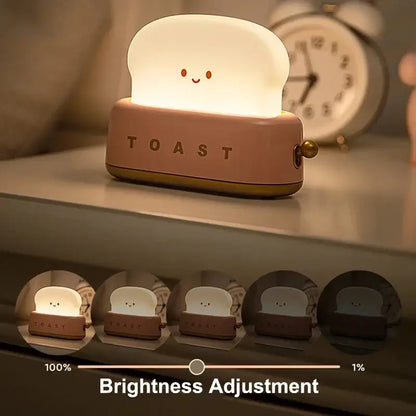 Soft pink and white silicone night light shaped like smiling toast with toast engraving for maker night light use